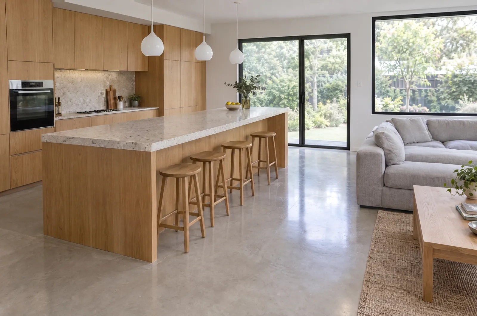 The same room with the movable clutter removed. The kitchen, island, stools, sofa, rug, pendant lights, windows and floor are unchanged.